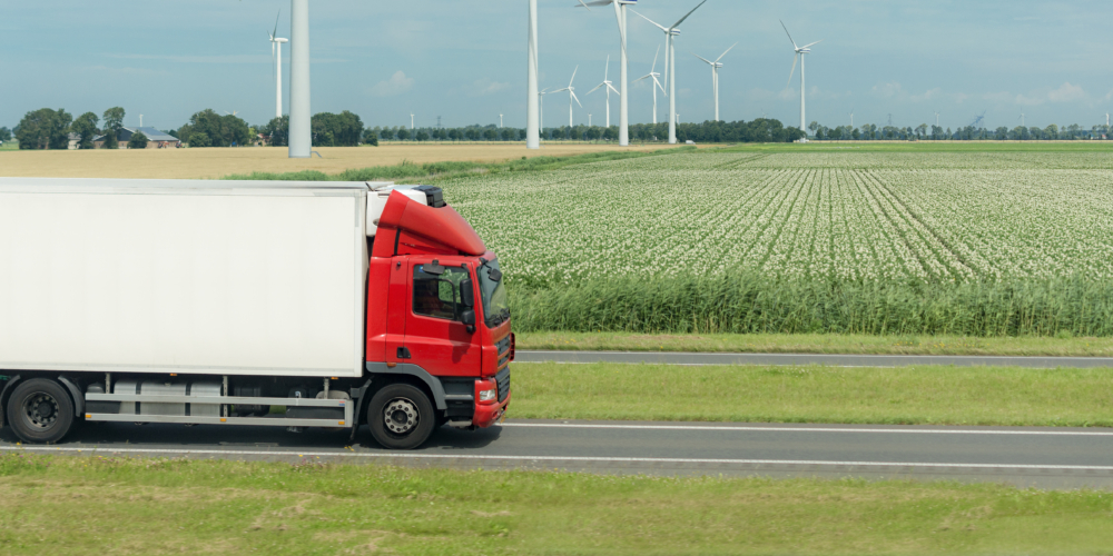 flat netherland  with truck, wind turbines and blooming crop
