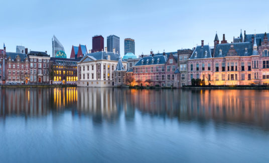 City Landscape, sunset panorama – view on pond Hofvijver and complex of buildings Binnenhof in from the city centre of The Hague
