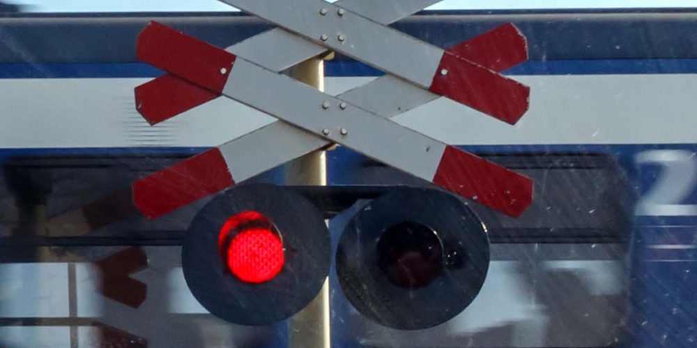 Train called Sprinter passes rail crossing in the Netherlands – Spoorwegovergang – Trein