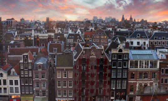 Roofs of Amsterdam at sunset,  Netherlands. Top view of old-time houses in Amsterdam, Netherlands.