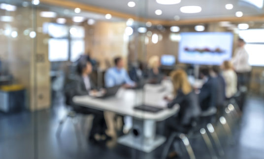 Soft focus business people sitting in conference room