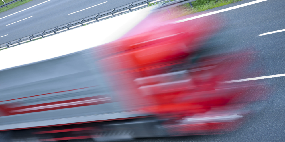 Truck speeding on highway, blurred motion, high angle view