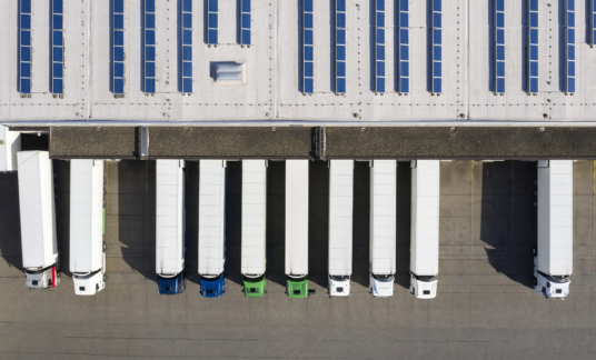 Aerial view of Semi-Trucks Loading at Logistic Center, Distribution Warehouse